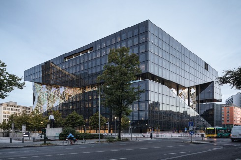 Die schwarzen, bedruckten Fassadenelemente sollen eine Reminiszenz an den Entwurf für das Glashochhaus (ca. 1922) von Mies van der Rohe in der Friedrichstaße sein.<br />