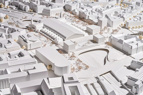 <span class="Bold"><strong>ein 3. Preis</strong></span> gmp mit WES binden den Neubau über ein tonnenförmiges Glasdach an. Da er niedriger ist, betont der Riegel den Bahnhof als Solitär. Die Jury lobte die Gestaltung des südlich anschließenden öffentlichen Raums.<br />