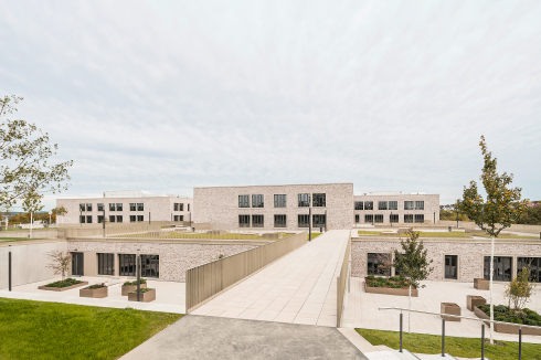 Der Schulneubau an der Autobahn läutet den Beginn einer großen Veränderung ein. Ab 2030 ist der schrittweise Bau eines neuen Zentrums geplant.<br />