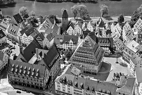 Mit 35 Meter Höhe überragt die Pyramide das Rathaus. Das war den Ulmern egal, als sie sich 1998 gegen den im Wettbewerb erstplatzierten Riegel der Kölner Minkus + Wolf und auch gegen den 2. Preis des Stuttgarters Volker Kurrle zugunsten von Gottfried Böhms eigenwilligem Glashaus entschieden.<br />